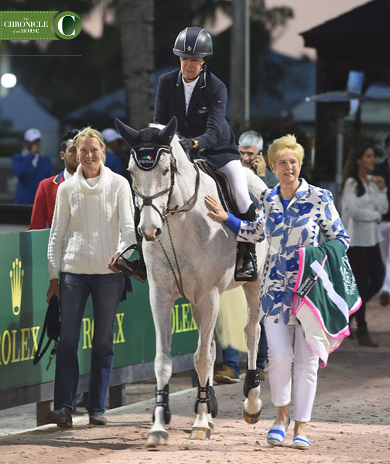 Laura Kraut rode Cedric into the ring for the last time, accompanied by his groom Johanna Burtsoff (left) and his owner, Margaret Duprey (right). Photo by Ann Glavan
